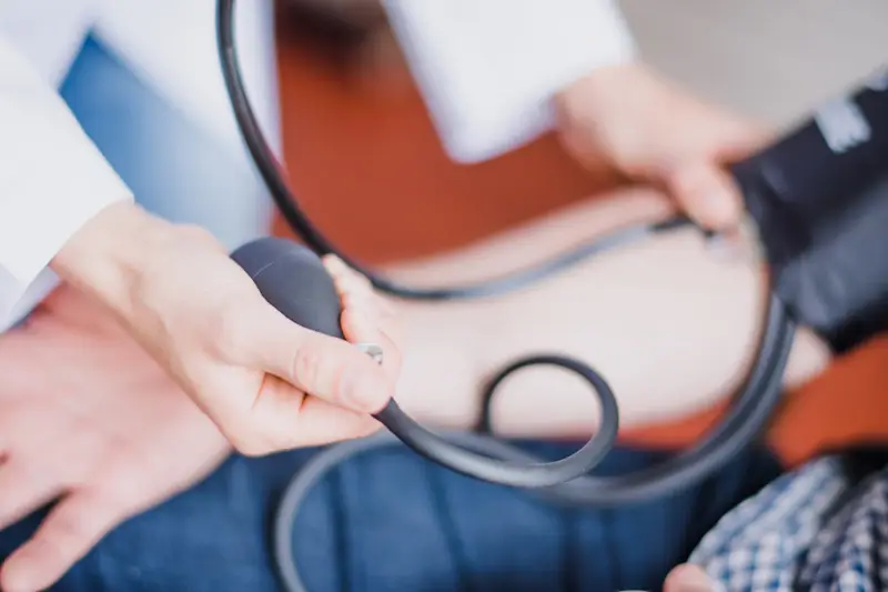 Occupational Health near me. Doctor taking an employees blood pressure.